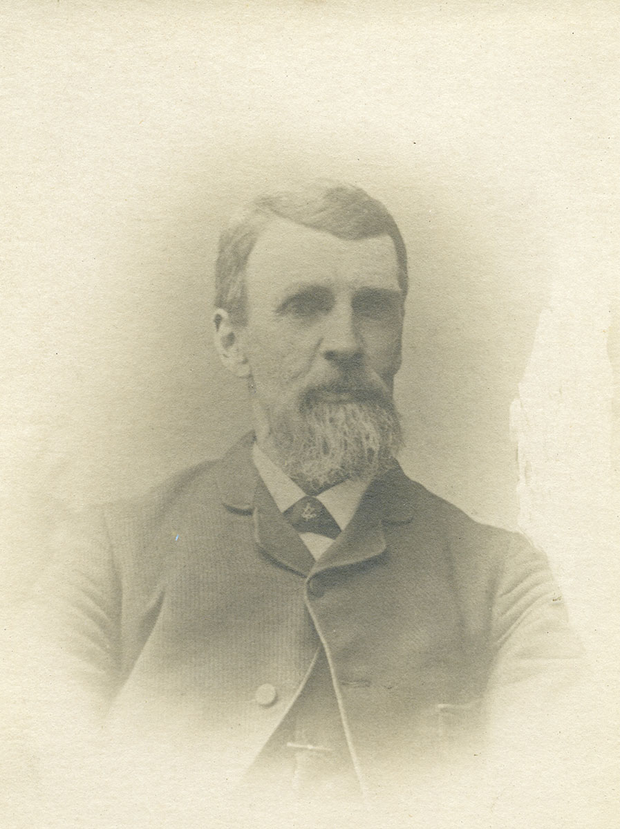 Historic image of an adult white male from the 1800s wearing a formal jacket and shirt.