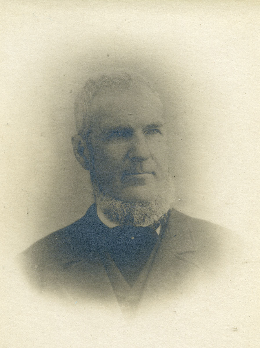 Historic image of an adult white male from the 1800s wearing a formal jacket and shirt.