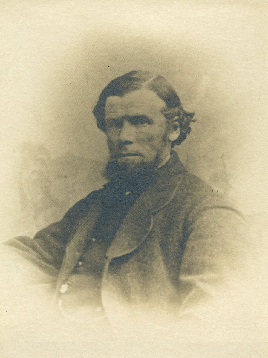Historic image of an adult white male from the 1800s wearing a formal jacket and shirt.