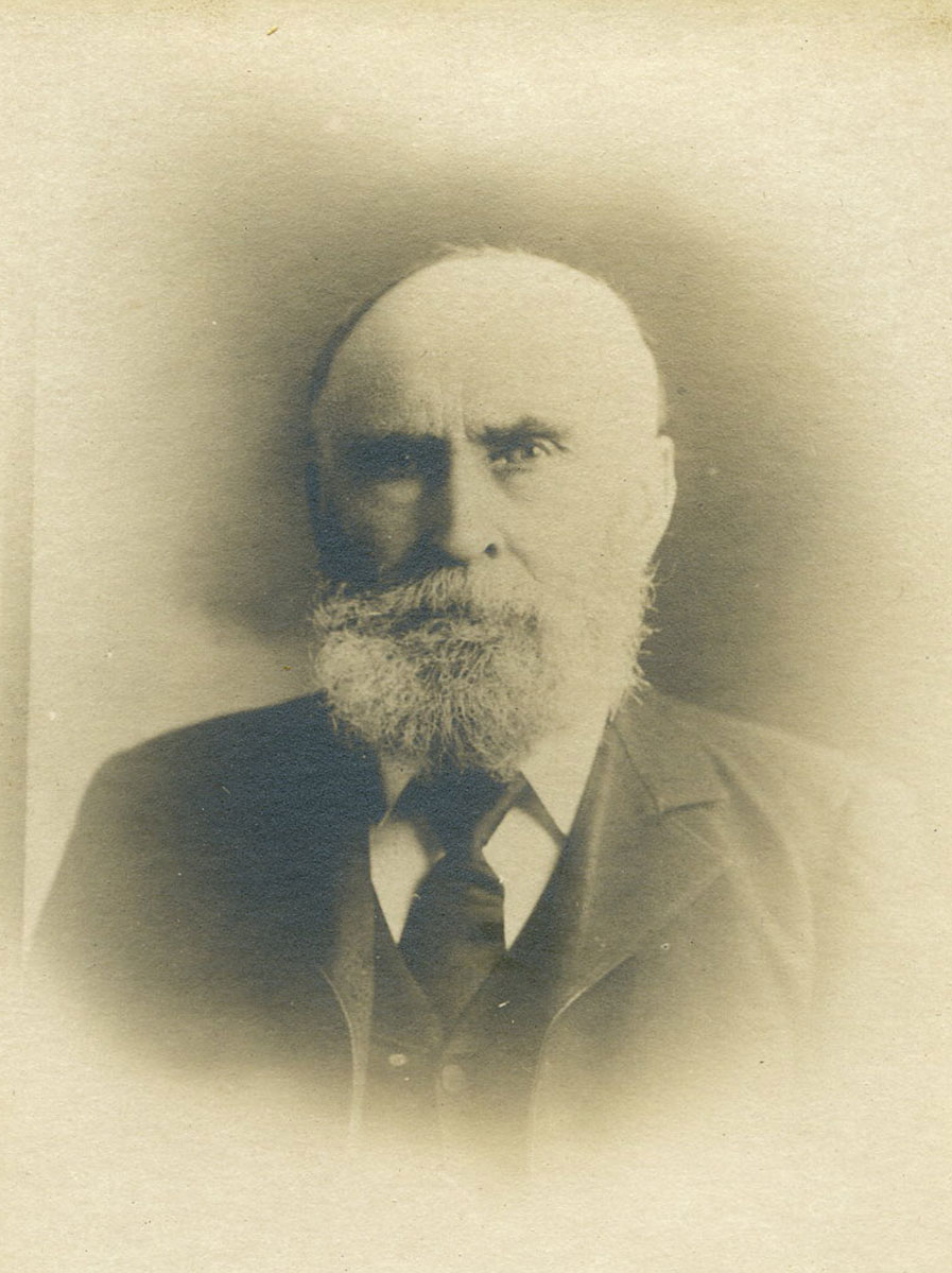 Historic image of an adult white male from the 1800s wearing a formal jacket and shirt.