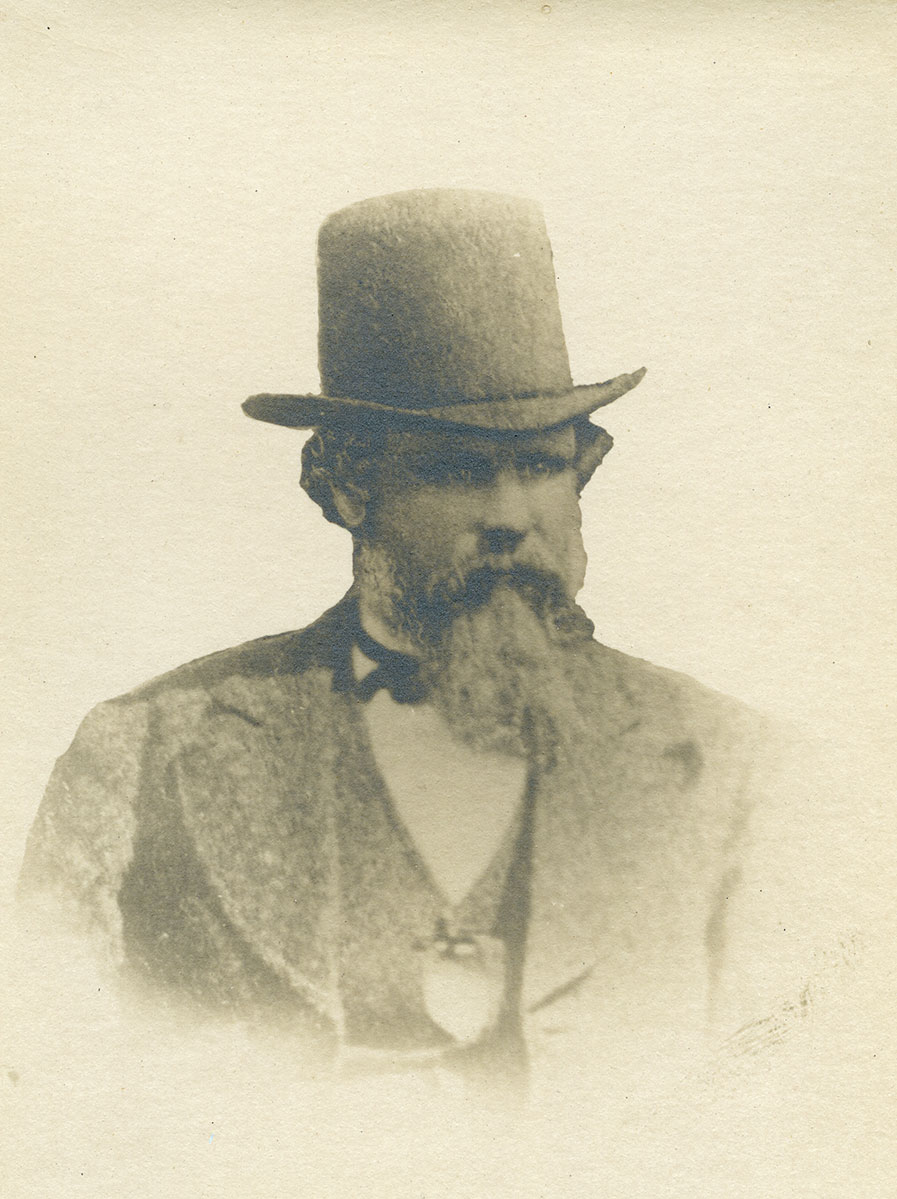 Historic image of an adult white male from the 1800s wearing a formal jacket and shirt.