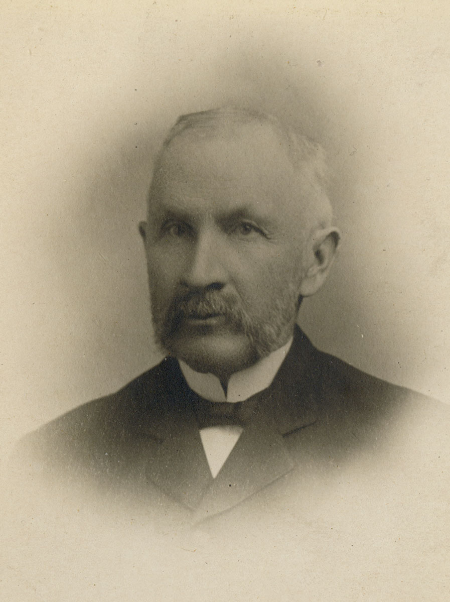 Historic image of an adult white male from the 1800s wearing a formal jacket and shirt.