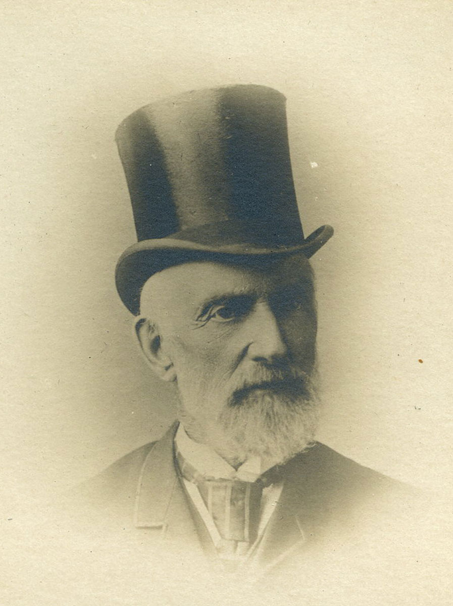 Historic image of an adult white male from the 1800s wearing a formal jacket and shirt.