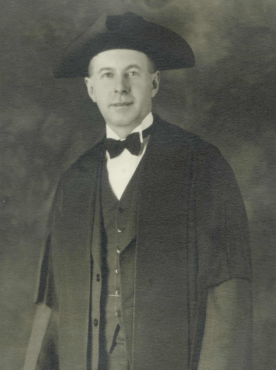 Historic image of an adult white male from the early 1900s wearing a formal jacket and shirt.