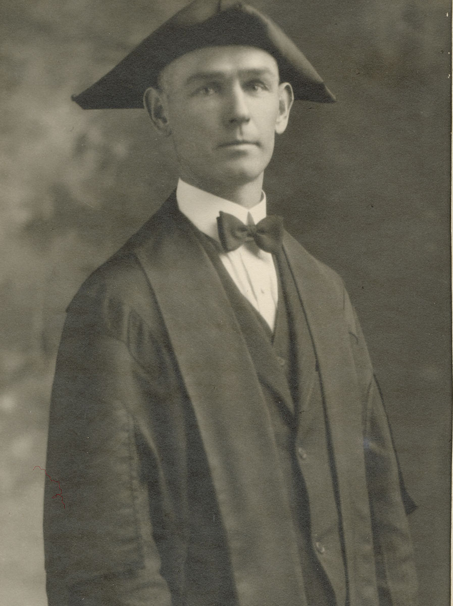 Historic image of an adult white male from the early 1900s wearing a formal jacket and shirt.