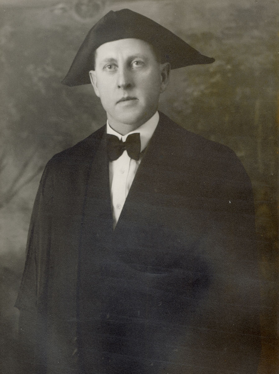 Historic image of an adult white male from the early 1900s wearing a formal jacket and shirt.
