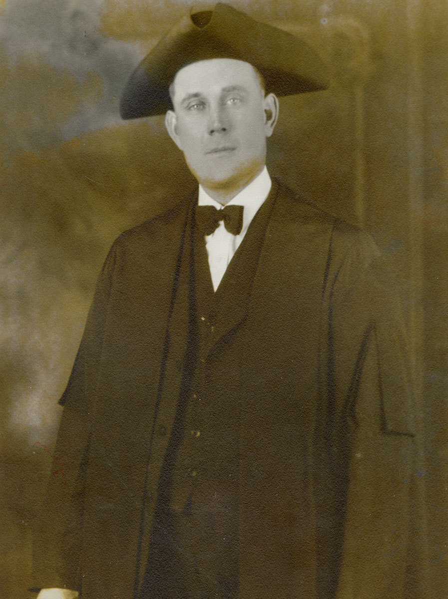 Historic image of an adult white male from the early 1900s wearing a formal jacket and shirt.