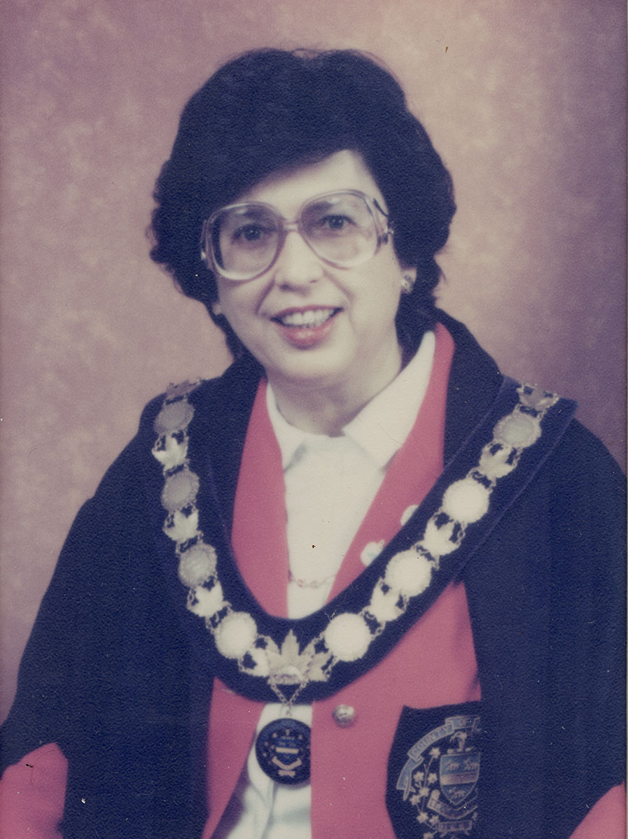 Photo of woman in a suit and warden medal.