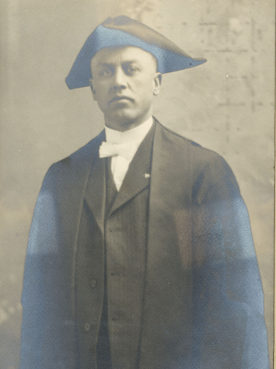 Historic image of an adult white male from the early 1900s wearing a formal jacket and shirt.