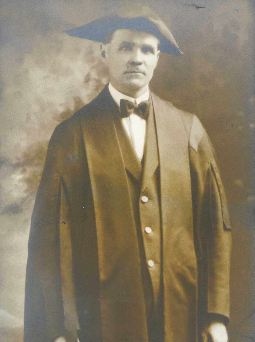 Historic image of an adult white male from the early 1900s wearing a formal jacket and shirt.