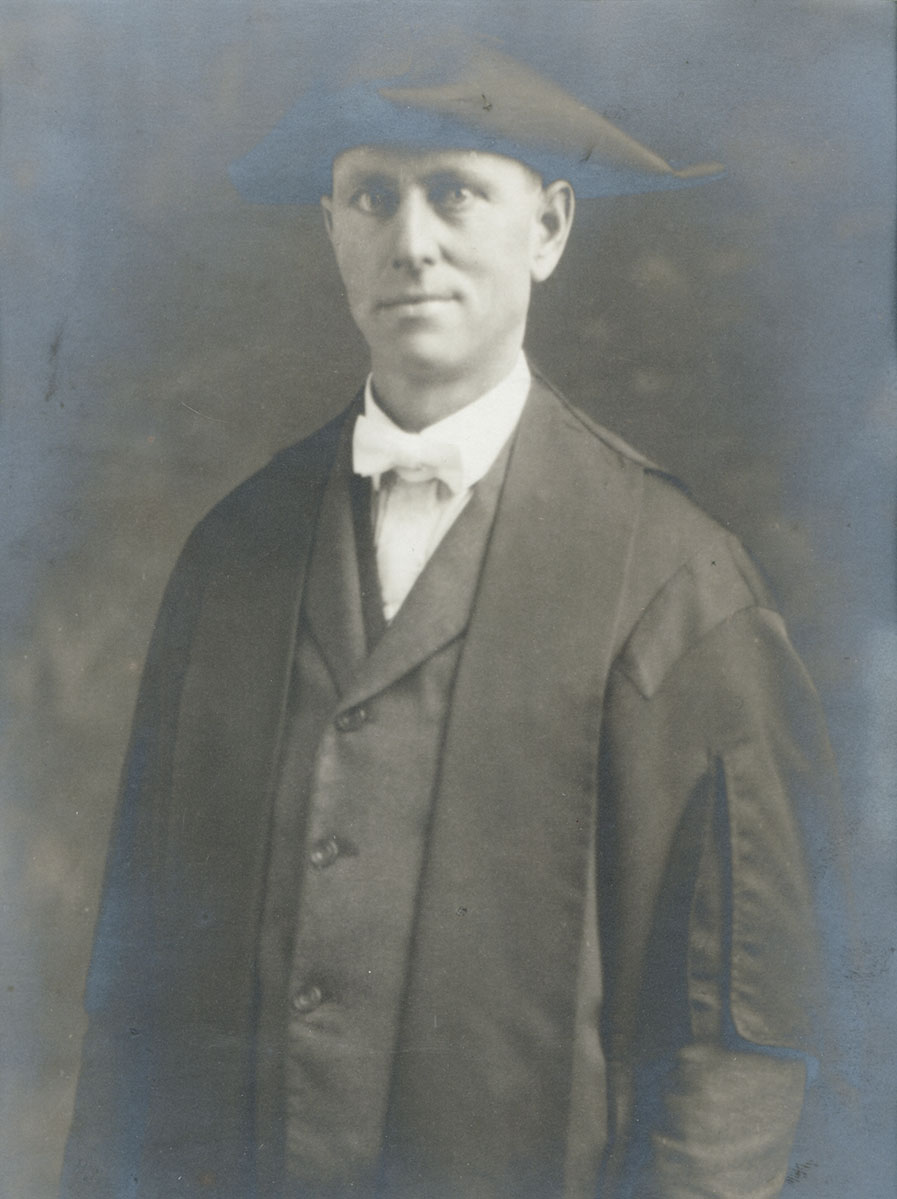 Historic image of an adult white male from the early 1900s wearing a formal jacket and shirt.