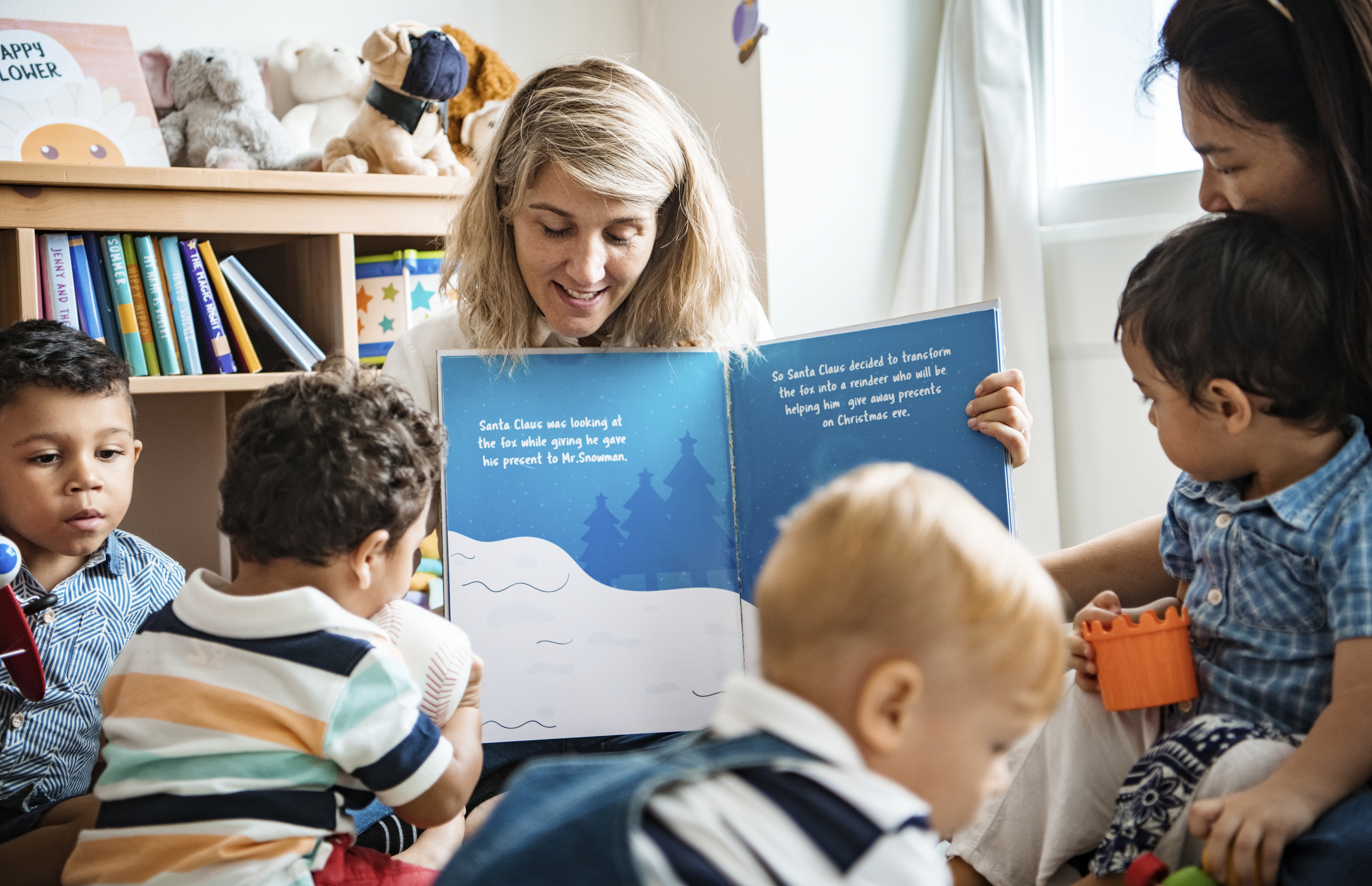 Photo of worker reading to children