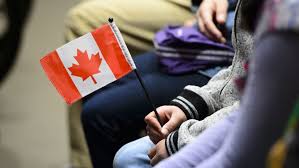 hand holding canadian flag