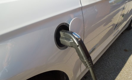 Electric car plugged into charging station