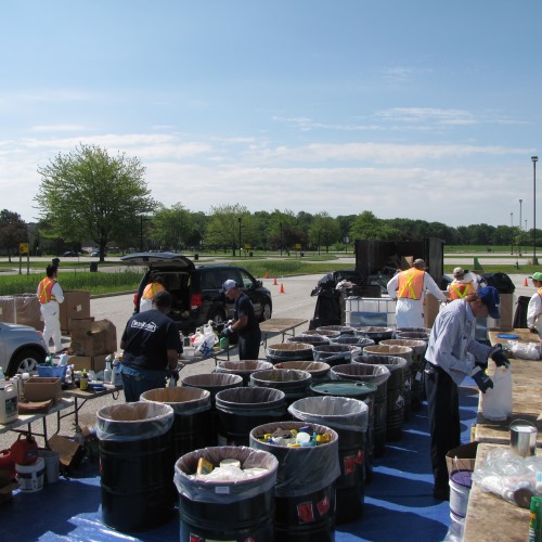 household hazardous waste collection event staff sorting materials into bins
