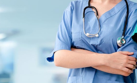 Health care worker wearing light blue scrubs