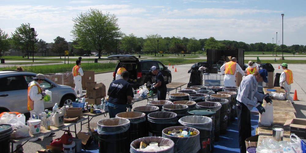 household hazardous waste collection event staff sorting materials into bins