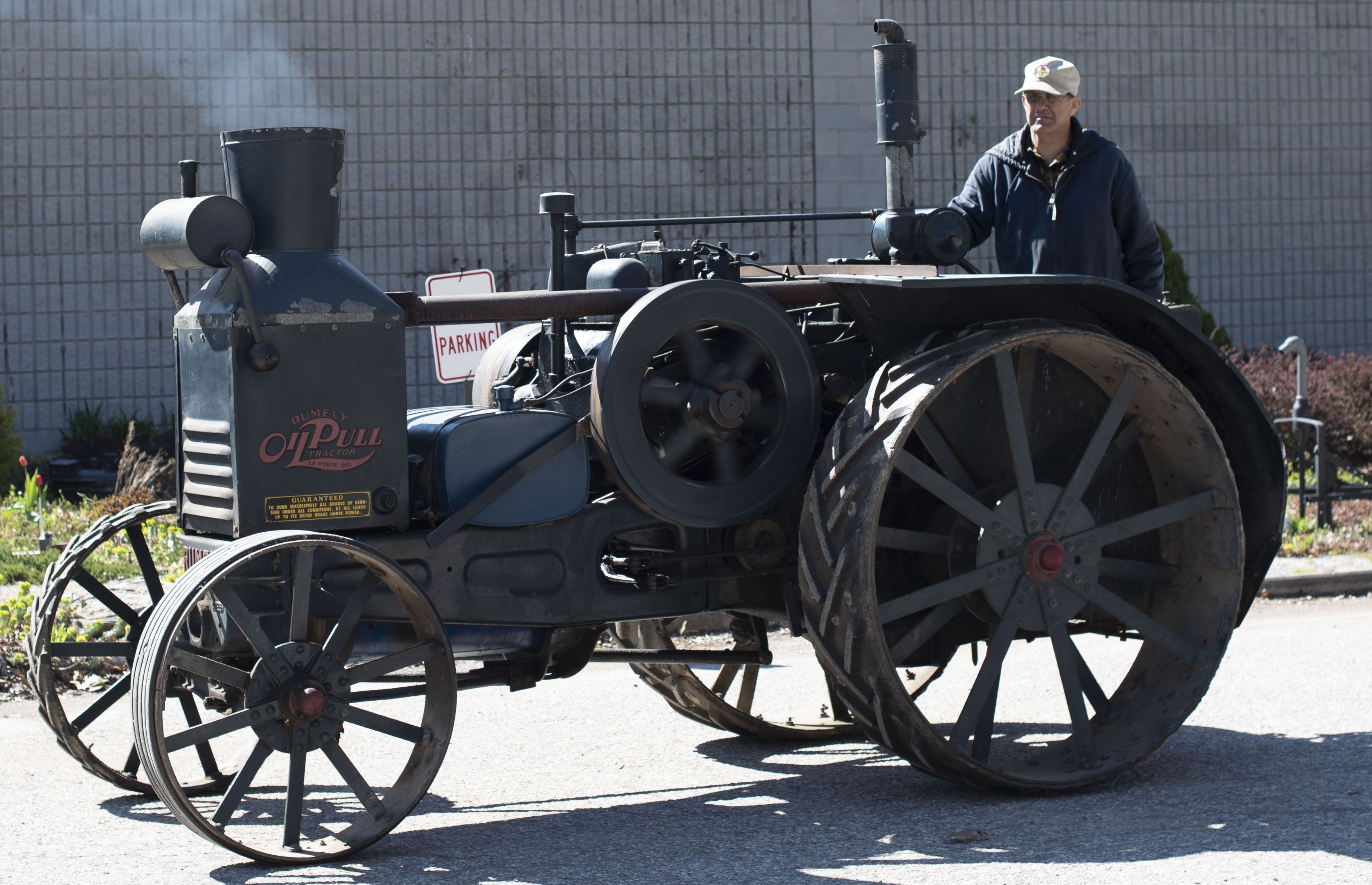 Lambton Heritage Museum staff member Jeremy Robson driving the historic Rumely tractor.