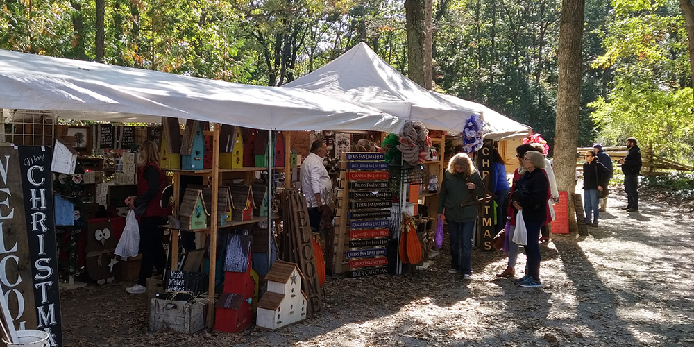 guests walking by a vendor tent at the Lambton Fall Colour & Craft Festival