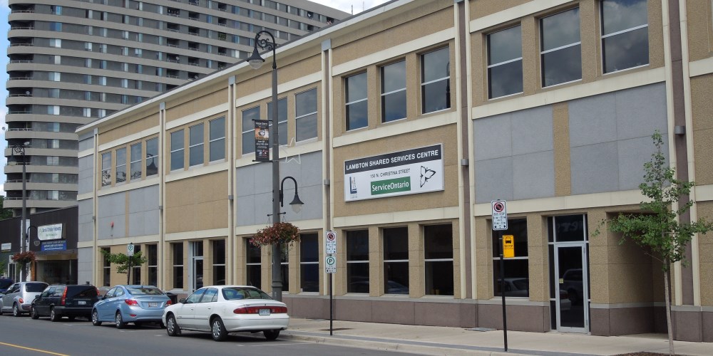 Exterior facade of Lambton Shared Services Centre with cars parked along road