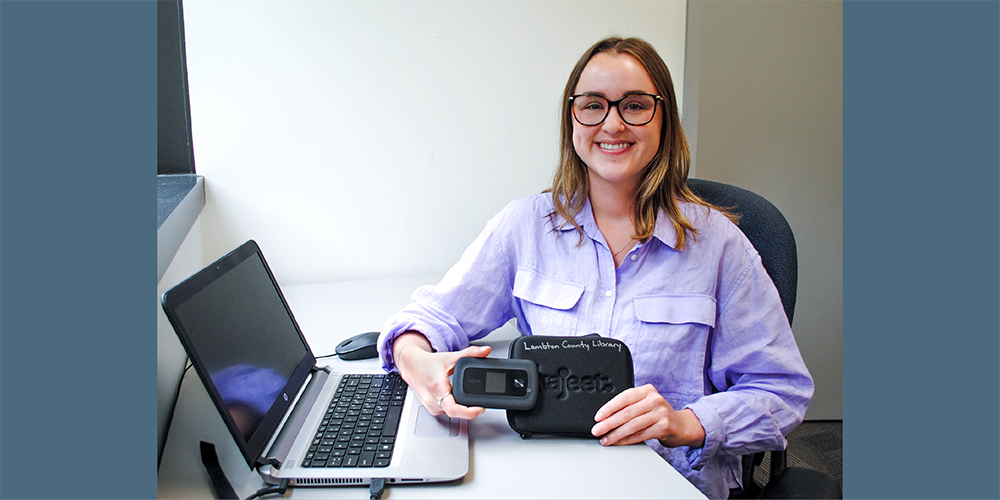 Ashlee Blackburn, Online Resource Communications Student, holds one of the Wi-Fi hotspots available to borrow from Lambton County Library