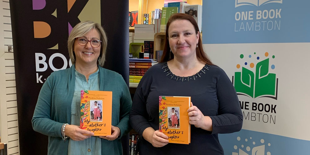 Susan Chamberlain from The Book Keeper and Greer Macdonell from Lambton County Library holding copies of My Mother’s Daughter by Perdita Felicien
