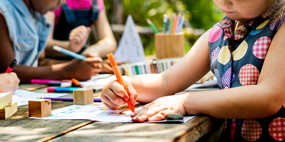 children working on arts and crafts at a table