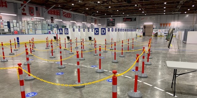 Rows of vaccinations pods and stanchions for line ups at the Point Edward Arena