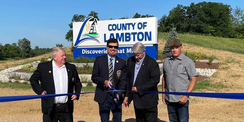Lambton County Councillor Steve Miller, Warden Kevin Marriot, Councillor Steve Arnold and Councillor Dave Ferguson cut the ceremonial ribbon in front of the 402 gateway sign
