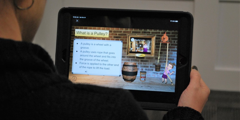 Person holding tablet viewing online learning materials