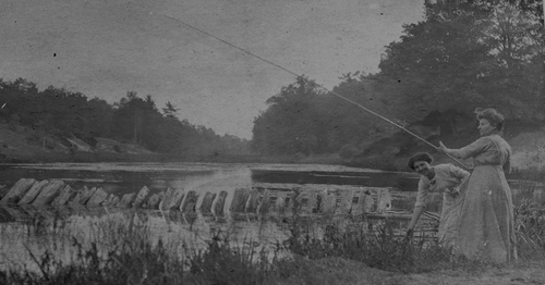 Historical photo of two women on a riverbank