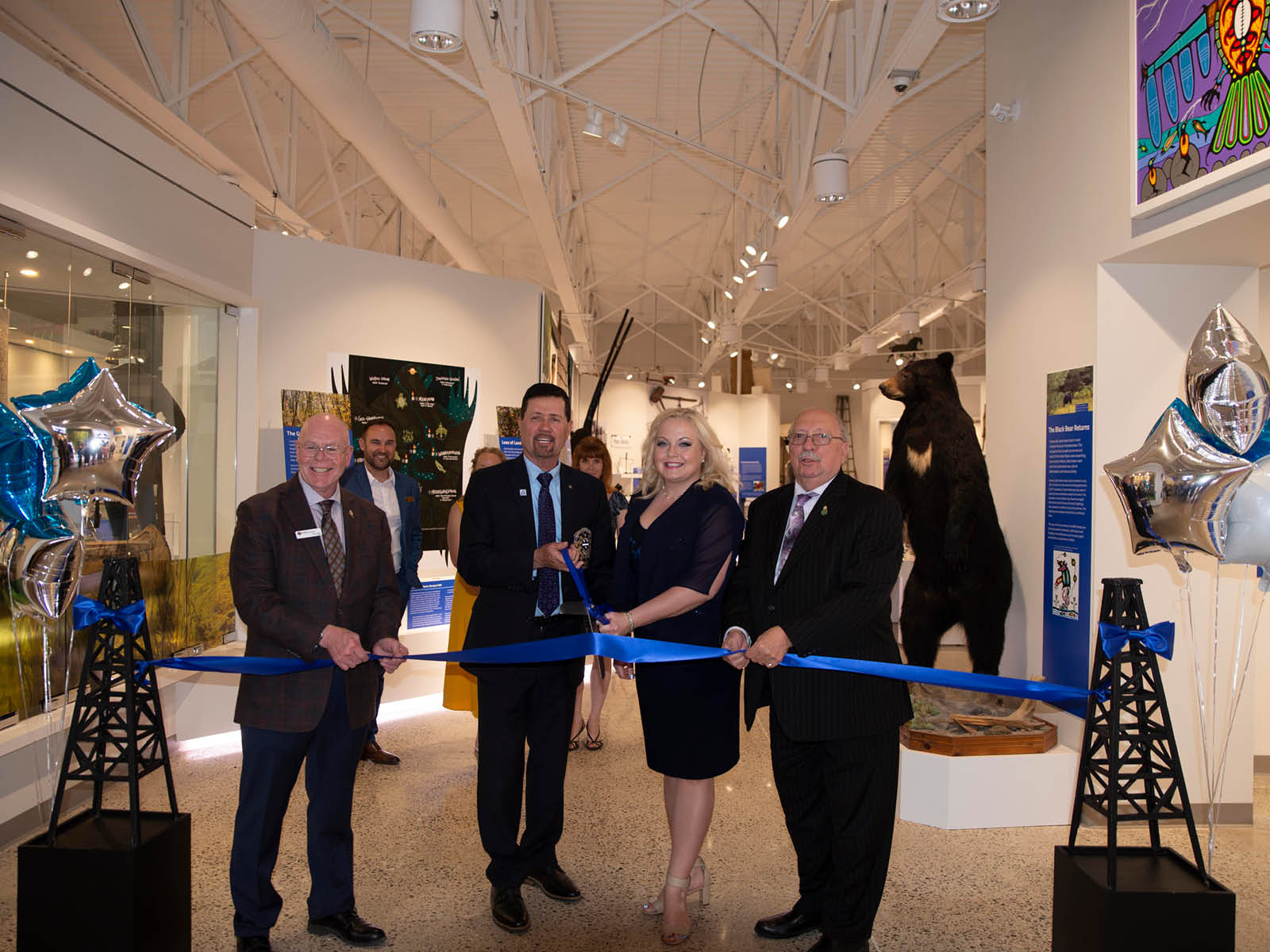 Lambton Shores Mayor and County Councillor Doug Cook cuts the ceremonial ribbon at the exhibit opening with Lambton County Warden Kevin Marriott, Lambton Kent Middlesex MP Lianne Rood, and Sarnia Lambton MPP Bob Bailey
