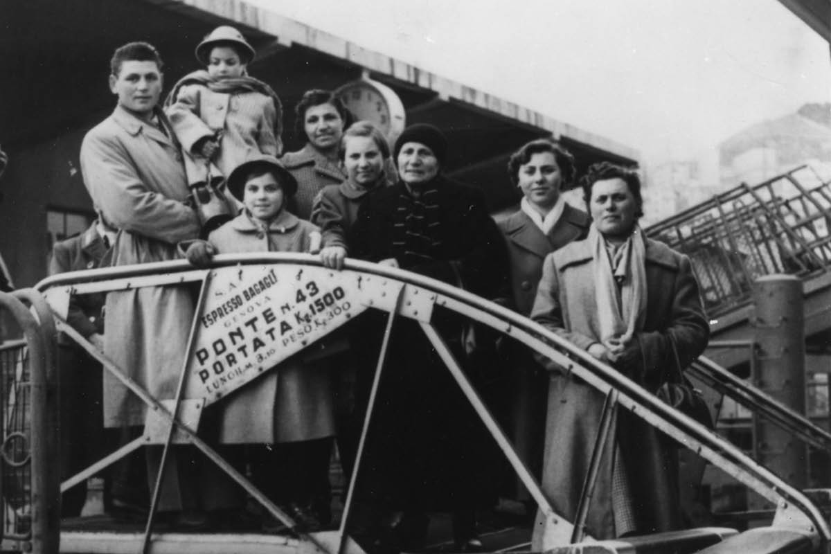 Black and white photo of immigrants arriving at a dock