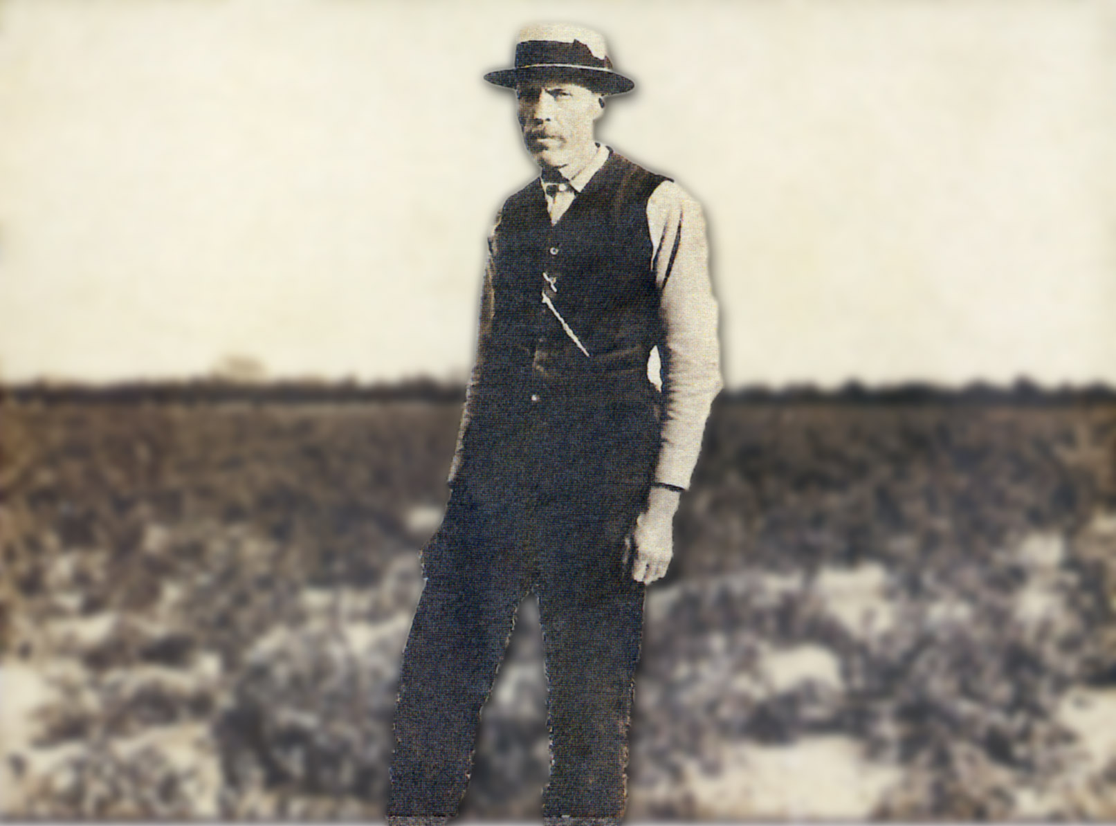 Historical photo of man standing in a field