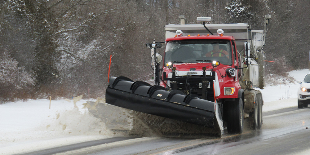 Snowplow clearing snow from roadway