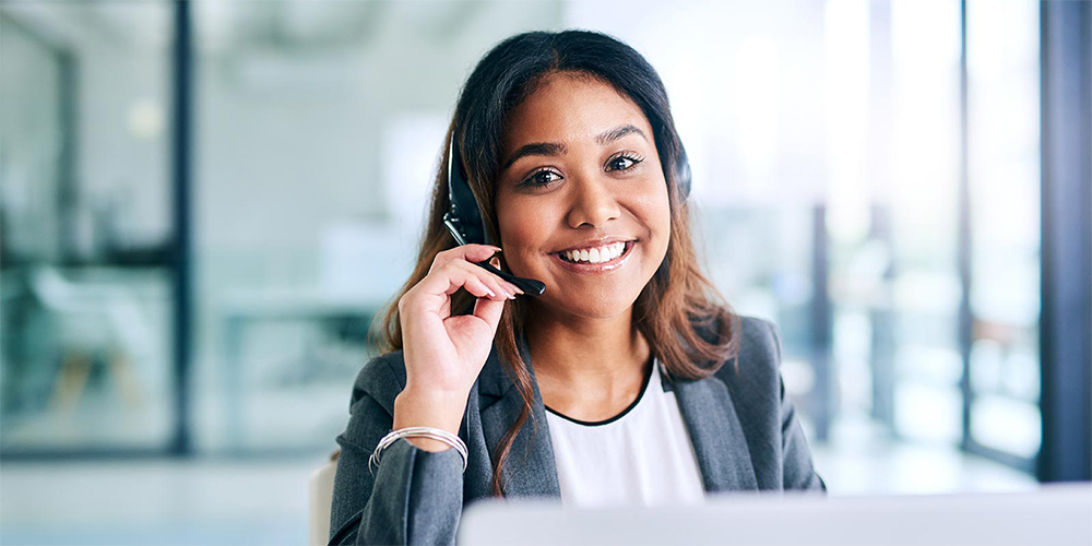 Woman wearing headset to answer calls in call centre