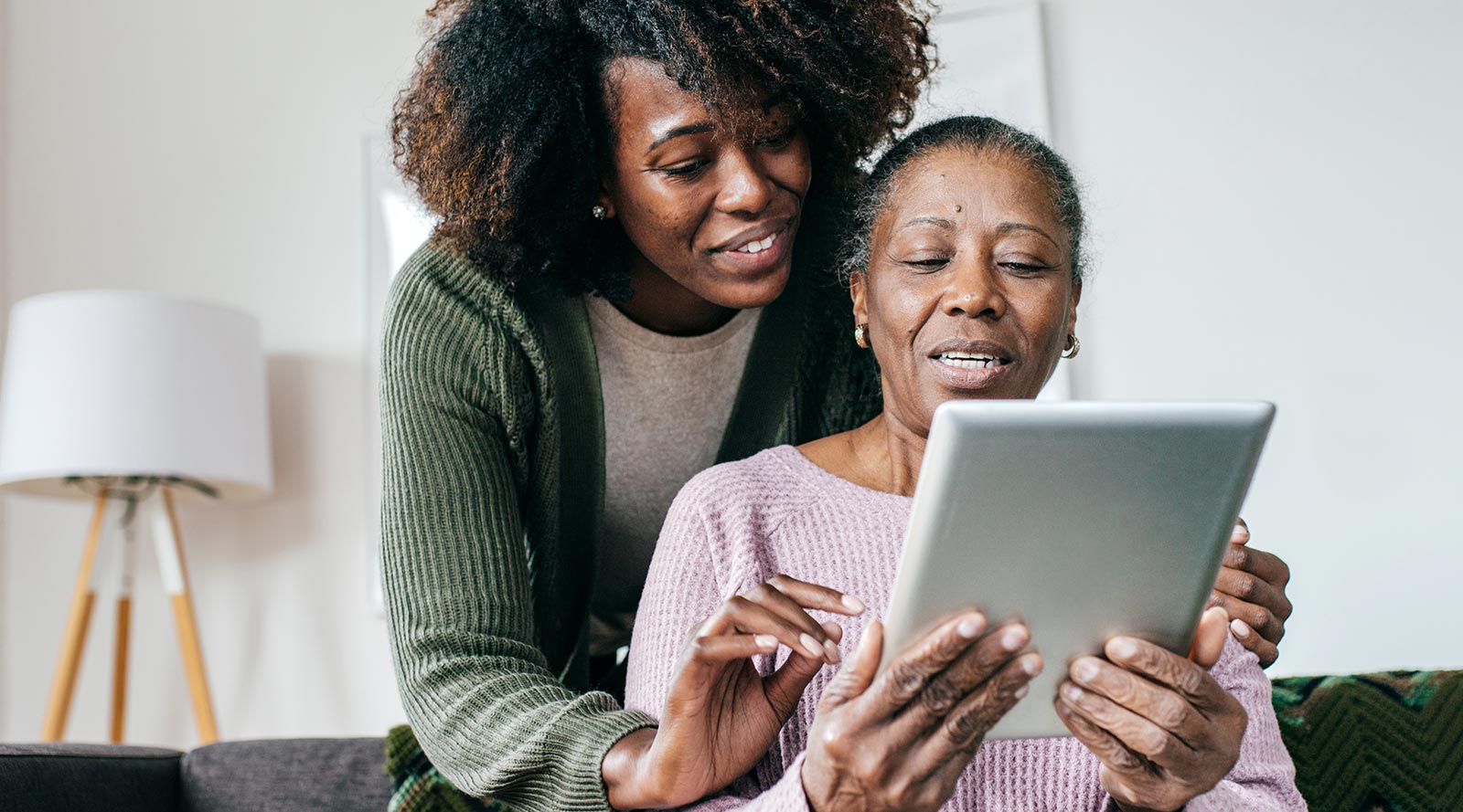 daughter helping mother with tablet