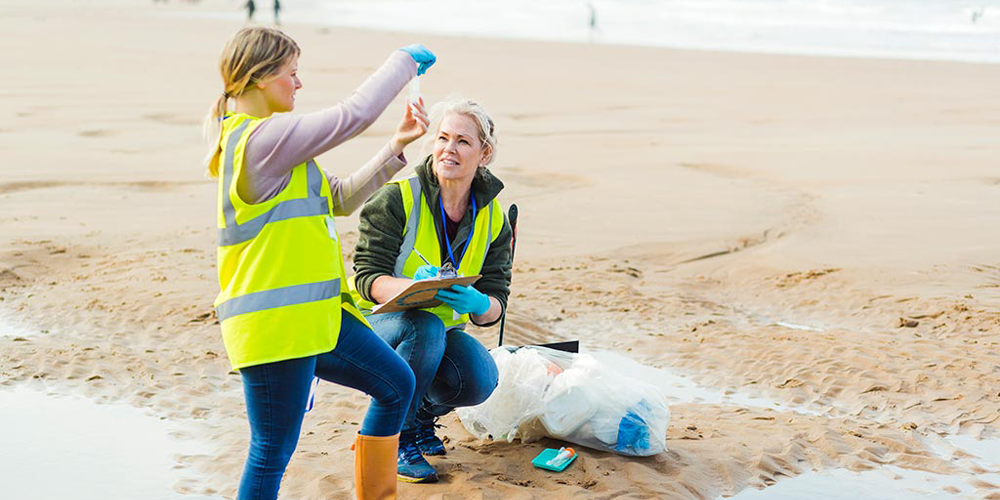 two women examining beach water samples