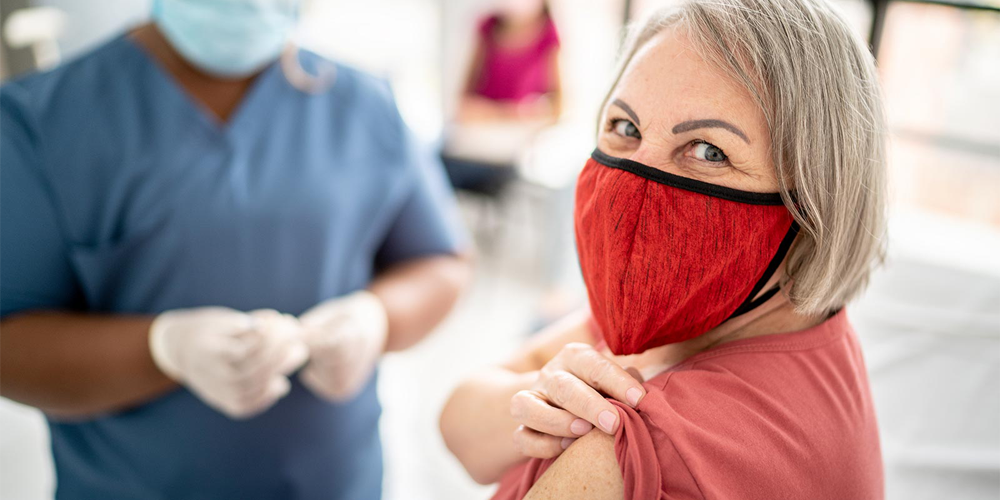 Woman wearing mask preparing to get vaccine